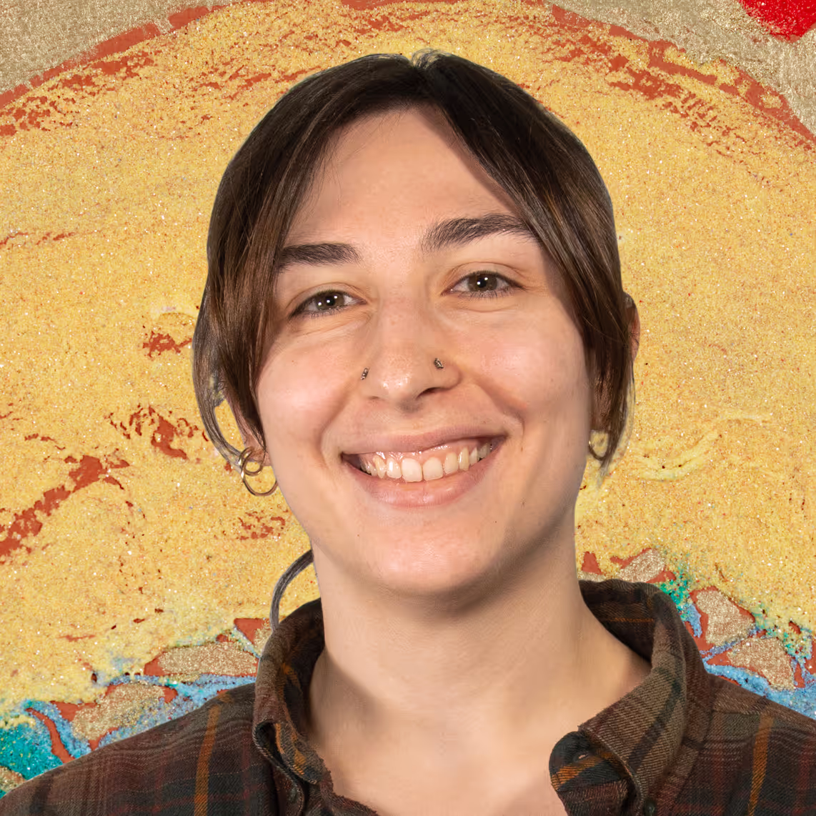 A woman smiling in front of a painting